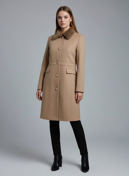 Woman wearing a beige coat with a fur collar on a gray background